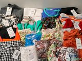 a lot of clothes that are sitting on a table