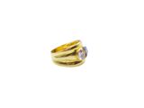a close up of a gold ring with a tan sapphire stone