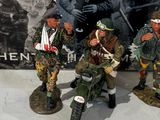 three figurines of soldiers sitting next to each other