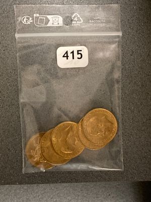 some gold coins are in a plastic bag on a table
