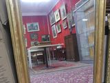 a mirror that is sitting on the floor in a room