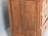 a small wooden dresser with three drawers on it