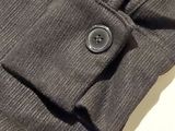 a close up of a buttoned shirt on a white surface