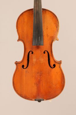 an old violin with a bow hanging from it ' s back
