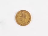 a close up of a gold coin on a white surface