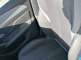 the back seats of a car in a parking lot with a car in the background