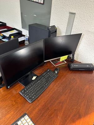 un bureau sur lequel sont posés deux écrans d'ordinateur et un clavier