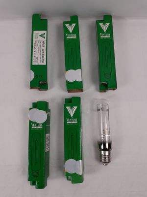 four different types of light bulbs in a box on a white surface