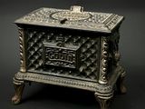 a small metal box with a lid on a stand