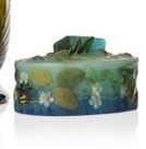 a glass vase and a soap bar sitting next to each other