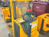a forklift with a container on it in a warehouse