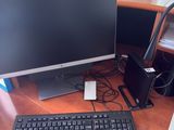 a computer desk with a keyboard and monitor on it