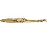 a close up of a gold chain bracelet with a heart on it