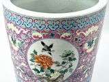 a vase with a bird and flowers on it