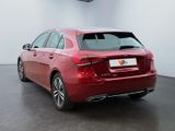 the rear end of a red car parked in a garage