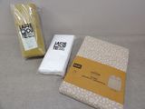 a bag of fabric next to a package of tissue