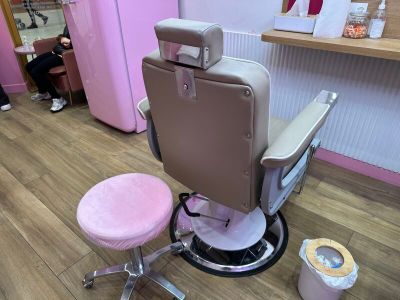 a pink chair and a pink stool in a room
