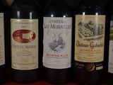 several bottles of wine are lined up on a red table