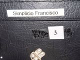 a black suitcase with a sign on it that says simpitio francisco