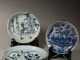 several blue and white plates are stacked on top of each other