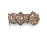 a close up of a bracelet on a white surface with a white background