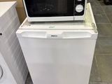 two microwaves sitting on top of each other on the floor