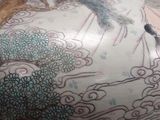 a vase with a dragon on it sitting on a table