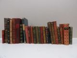 many old books stacked on top of each other on a table