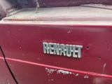 a close up of a red car with the word renault on it