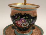 a tea cup and saucer on a saucer on a plate