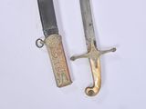 two knives that are laying side by side on a table