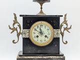 a black and gold clock sitting on top of a table