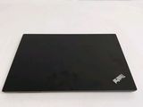 a black laptop sitting on a white surface