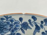 a blue and white bowl with a flower design on it