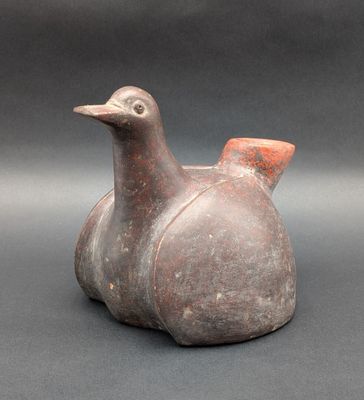 une image représentant un vase en forme d'oiseau posé sur une table