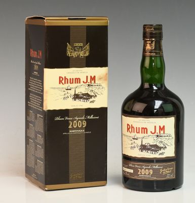 an image of a bottle of rumm j m whisky next to a box