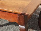 a wooden table with a wooden top on the street