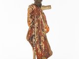 a statue of a man with a wooden stick in his hand