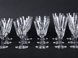 a set of six crystal wine glasses on a black background
