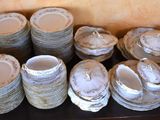 many different types of plates and bowls on a table