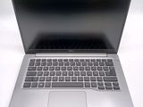an open laptop computer sitting on top of a white table
