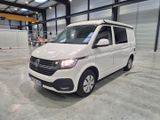 the white van is parked in a large warehouse with its roof open