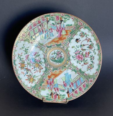 an ornately decorated plate with flowers and birds on a black background