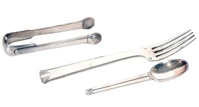 three spoons and a fork on a white surface