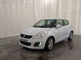 the small white car is parked in a large room