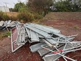 a pile of metal items on the ground in the dirt