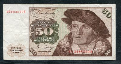 un gros plan d'un billet de banque sur lequel figure le portrait d'un homme