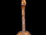 statue of a woman on a cross made of wood on a black background