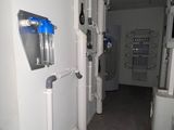 a room with a lot of pipes and a water dispenser