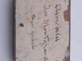 a small box with writing on it sitting on a table